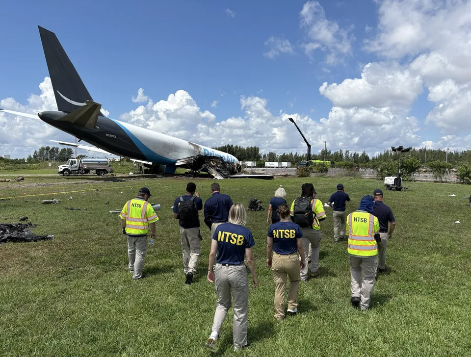 NTSB investigators examining the wreckage field of 21 Air Flight 7598 at Miami.