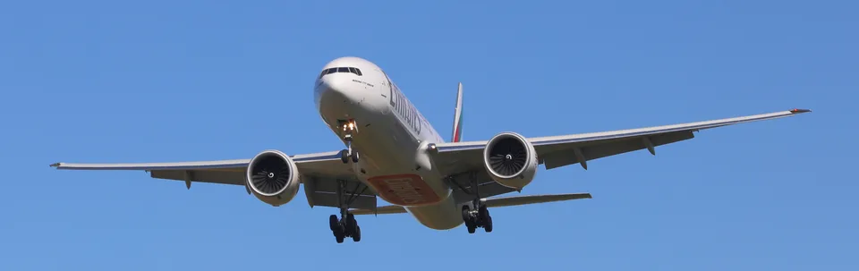 Emirates Boeing 777 A6-EQI in flight with its landing gear extended.