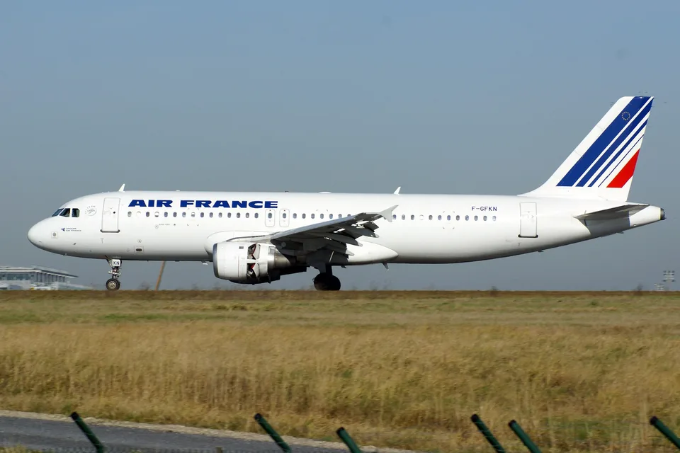 Air France Airbus A320 F-GFKN with landing gear extended at Paris Charles de Gaulle.