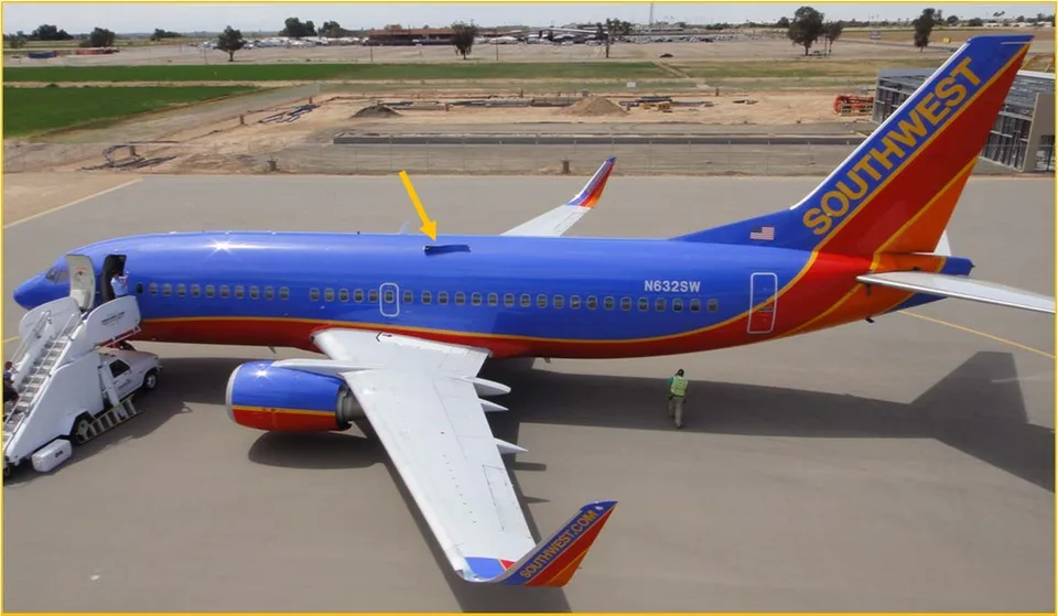 Southwest Boeing 737 N632SW on the ground with an arrow marking the opening above the left wing.