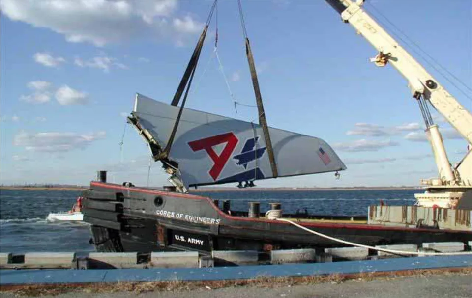 Recovered American Airlines 587 vertical stabilizer suspended from a crane beside Jamaica Bay.
