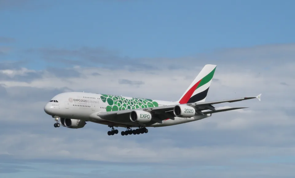 Emirates A6-EON approaching Munich with landing gear extended and green Expo 2020 markings.