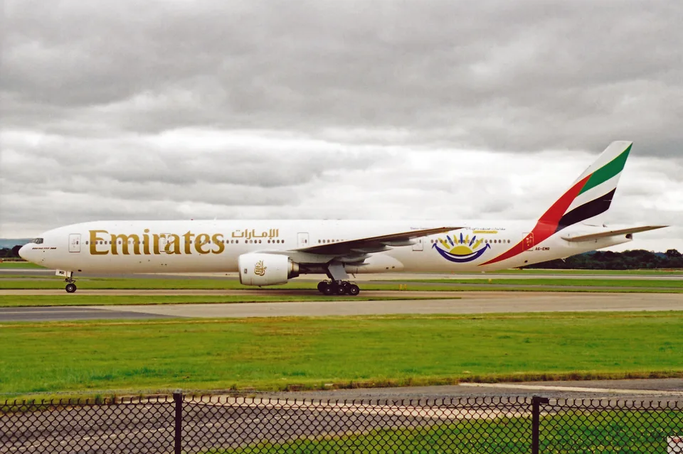 Emirates Boeing 777-300 A6-EMR on the ground at Manchester with Summer Surprise artwork.