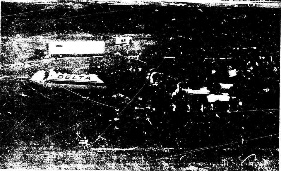 Aerial view of Delta 1141 wreckage beyond the runway at Dallas-Fort Worth.