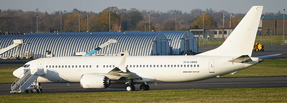 Boeing 737-8 G-CRUX in white paint on the ground at Prestwick.