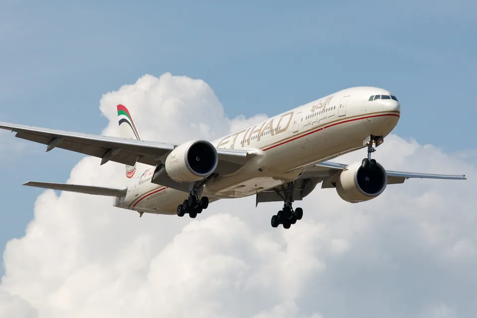 Boeing 777 A6-ETC in Etihad colours approaching Toronto with its landing gear extended.