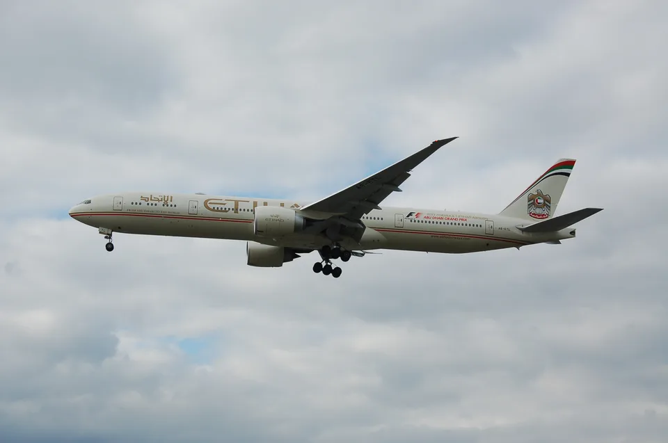 Etihad Airways Boeing 777 A6-ETL approaching London Heathrow with its landing gear down.