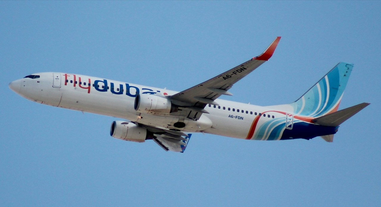 flydubai Boeing 737-8KN A6-FDN in flight, seen from below against a blue sky
