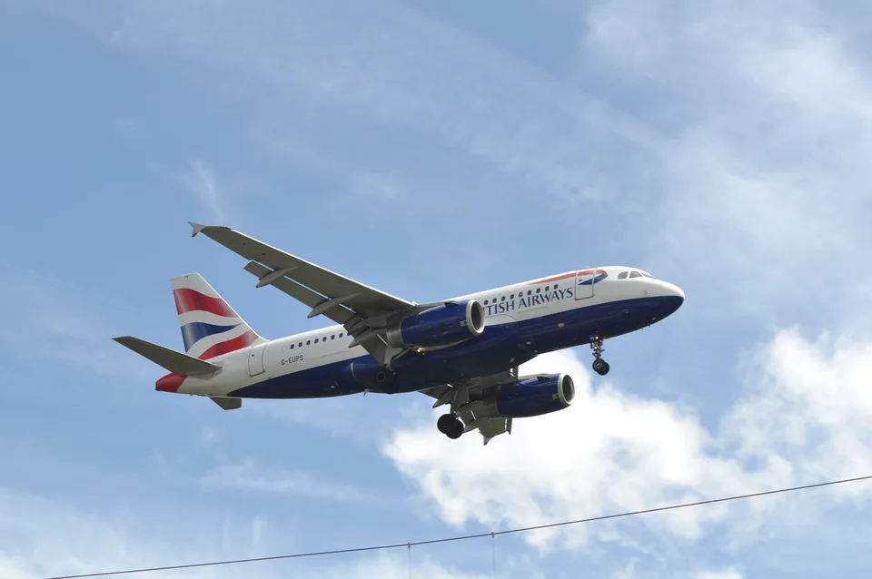 British Airways Airbus A319 G-EUPS with landing gear extended at Heathrow.