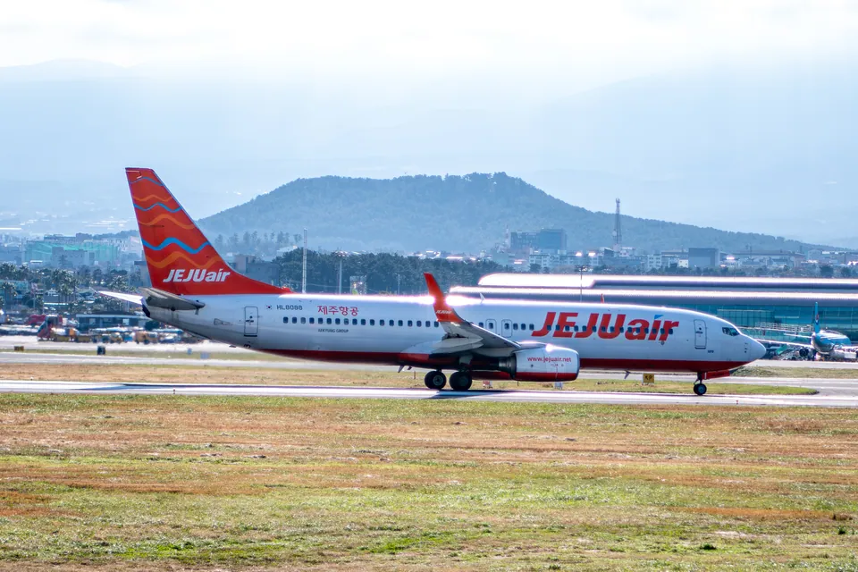 Jeju Air Boeing 737-800 HL8088 with its landing gear extended at Jeju International Airport.