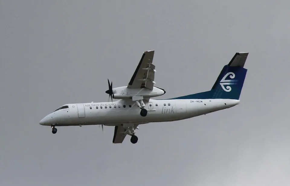 Air New Zealand Q300 ZK-NEM in flight with landing gear extended