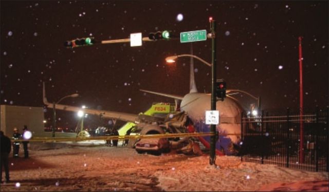 N471WN stopped beside an automobile in the snowy roadway intersection outside Midway.