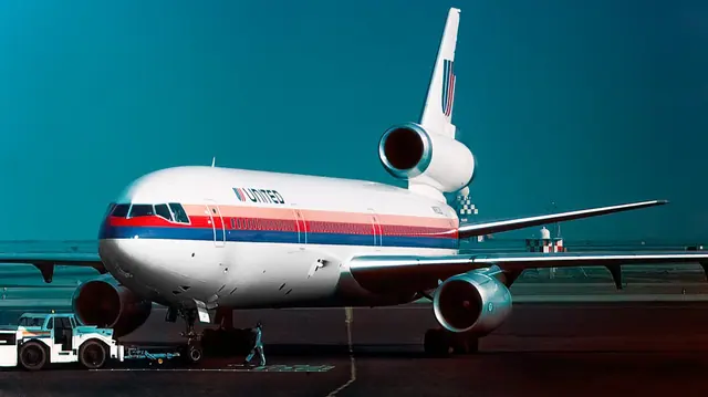 United DC-10 N1819U viewed from the front on an apron, with the tail-mounted engine above the fuselage.
