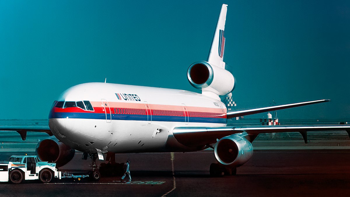 United DC-10 N1819U viewed from the front on an apron, with the tail-mounted engine above the fuselage.